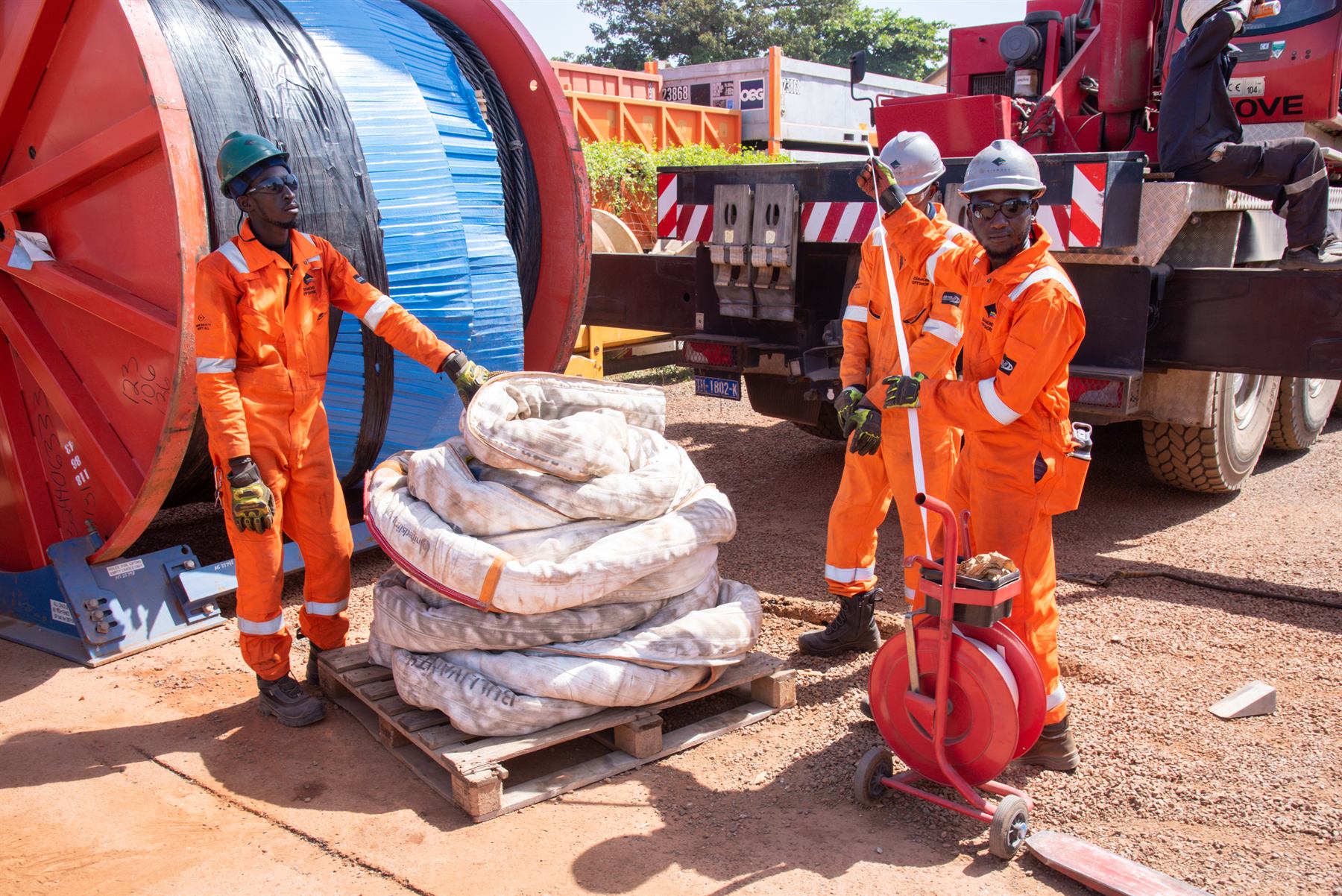SILS crew in orange PPE handling a palletised load in the yard